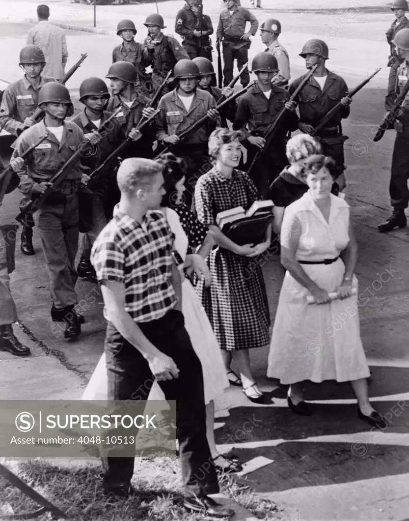 Armed National Guardsmen disperse a group of White students as they staged a walkout from Central High School in Little Rock, Arkansas, to protest integration. Sept. 1957