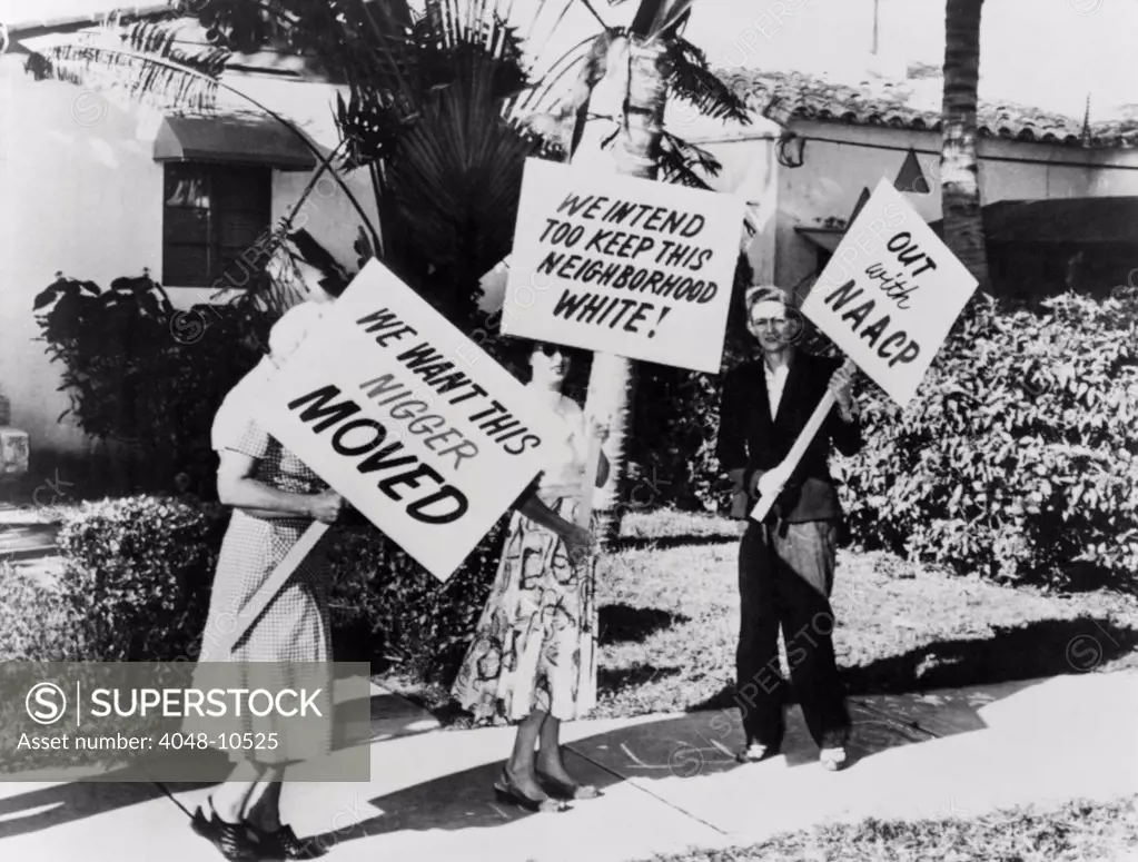 African American singer Frank Legree's home was picketed. Three White people carrying signs with racist slogans in front his house in Miami, Florida. 1957.
