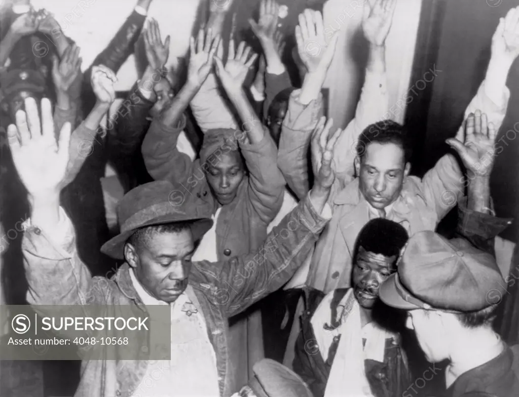 State highway patrolmen search group of Negroes arrested during rioting on Feb. 26, 1946. The Columbia, Tennessee riot began with a minor business dispute between White clerk and a Black World War II veteran. Police reacted with illegal searches and seizures, arresting of over 100, and the death of two in police custody.