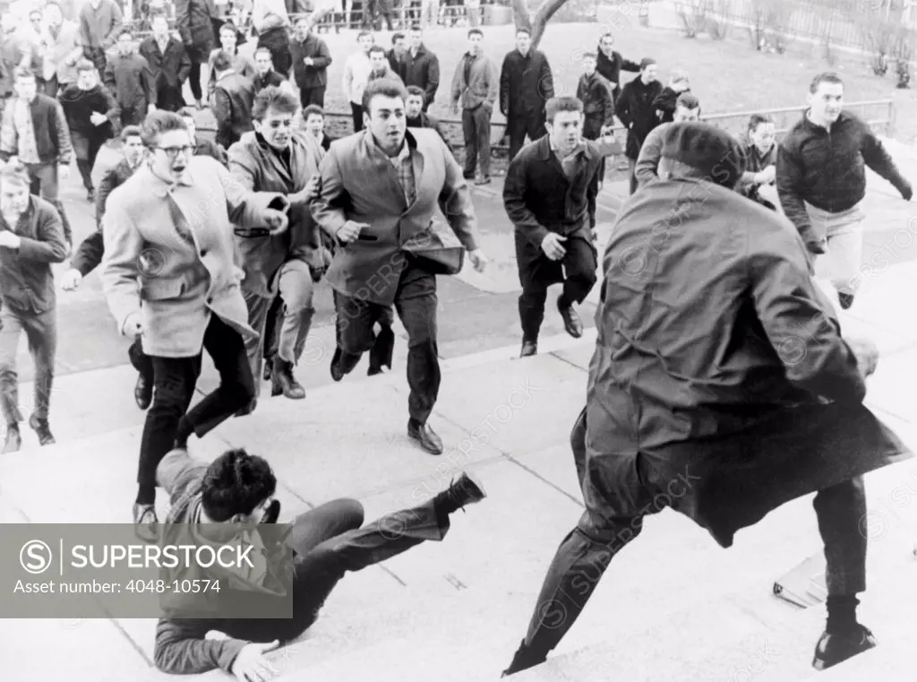 White students running toward an African American during period of racial violence at Collinwood High School in Cleveland, Ohio. March 1965.