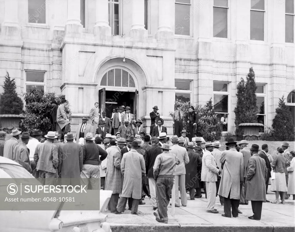 Legal retaliation for Montgomery Bus Boycott. Ninety bus boycott leaders gather outside the courthouse in Montgomery, Alabama, after arraignment for participation in the bus boycott. They were charged with violating a statue barring boycotts without just cause. February 25, 1956.