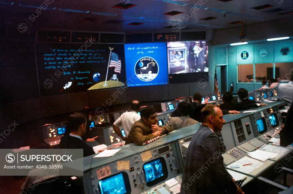 NASA Mission Control during Apollo 11 moon mission. Monitors show President Richard Nixon greeting the astronauts aboard the USS Hornet. July 24, 1969