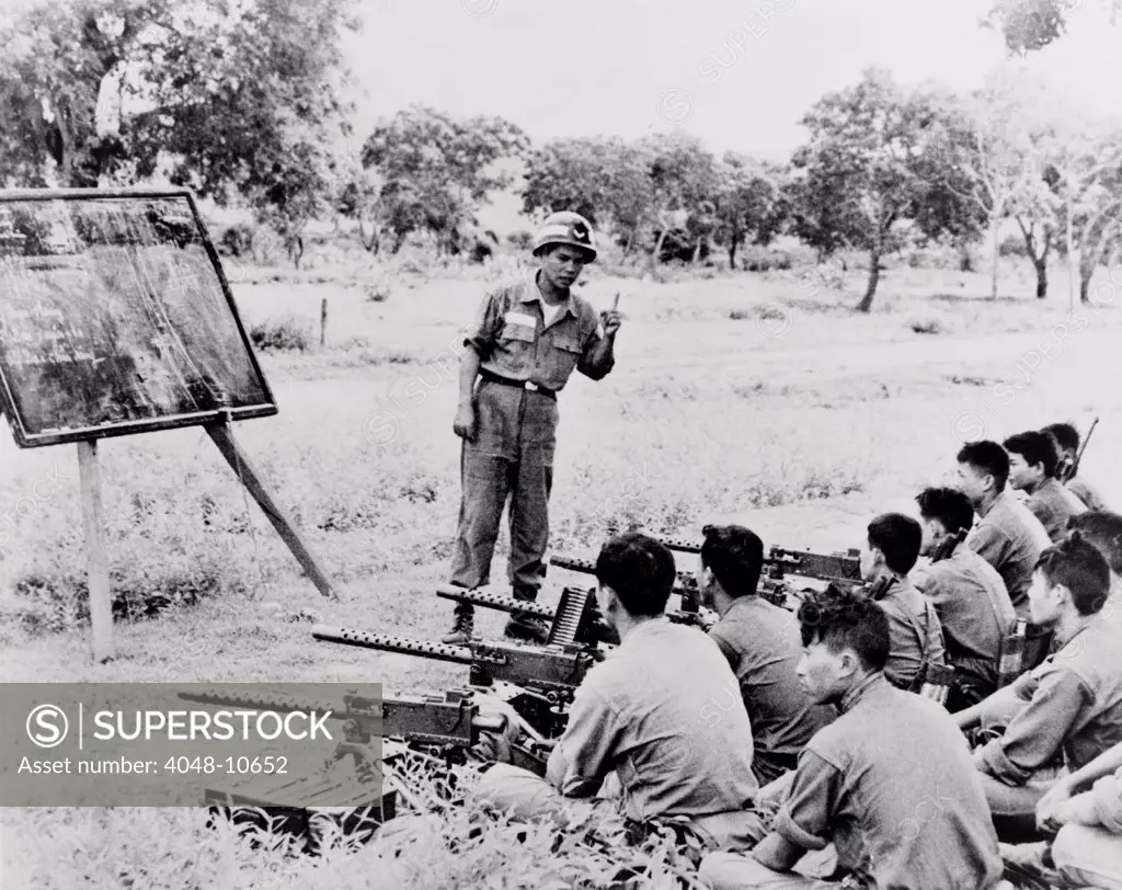 Vietnamese Civil Guard troops receiving training on the use of Browning light machine gun in Song Mao, Vietnam. 1963.