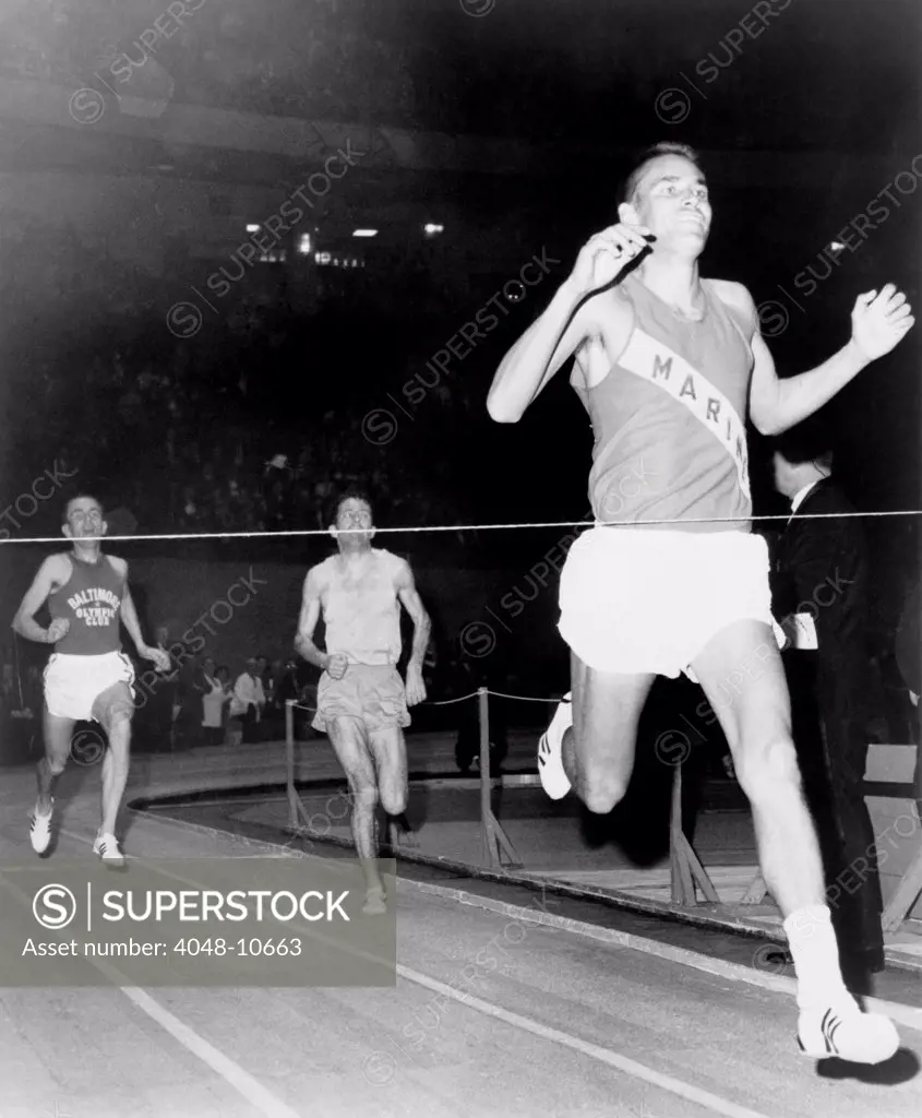 Olympic Champion, Billy Mills, wins the three-mile run at Madison Square Garden in 1965. Mills became the second Native American to receive an Olympic gold medal when he won the 10,000 meter run at the 1964 Tokyo Olympics. Mills was portrayed by Robby Benson in the 1983 film RUNNING BRAVE.