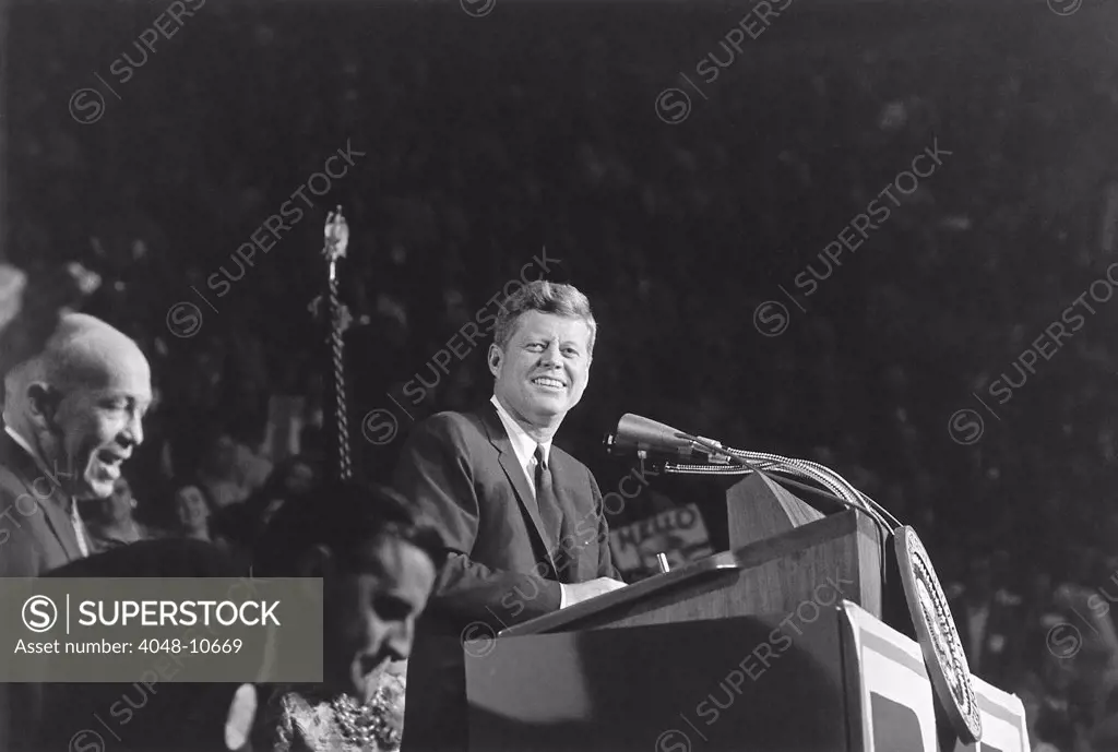 President Kennedy speaks at 'Bean Feed' on Oct. 6, 1962. Minnesota's 'Democratic-Farmer-Labor party'(DFL) held 'Bean Feed' gatherings across the state where voter could meet politicians. At lower left is future Vice President, the Minnesota Attorney General, Walter Mondale.