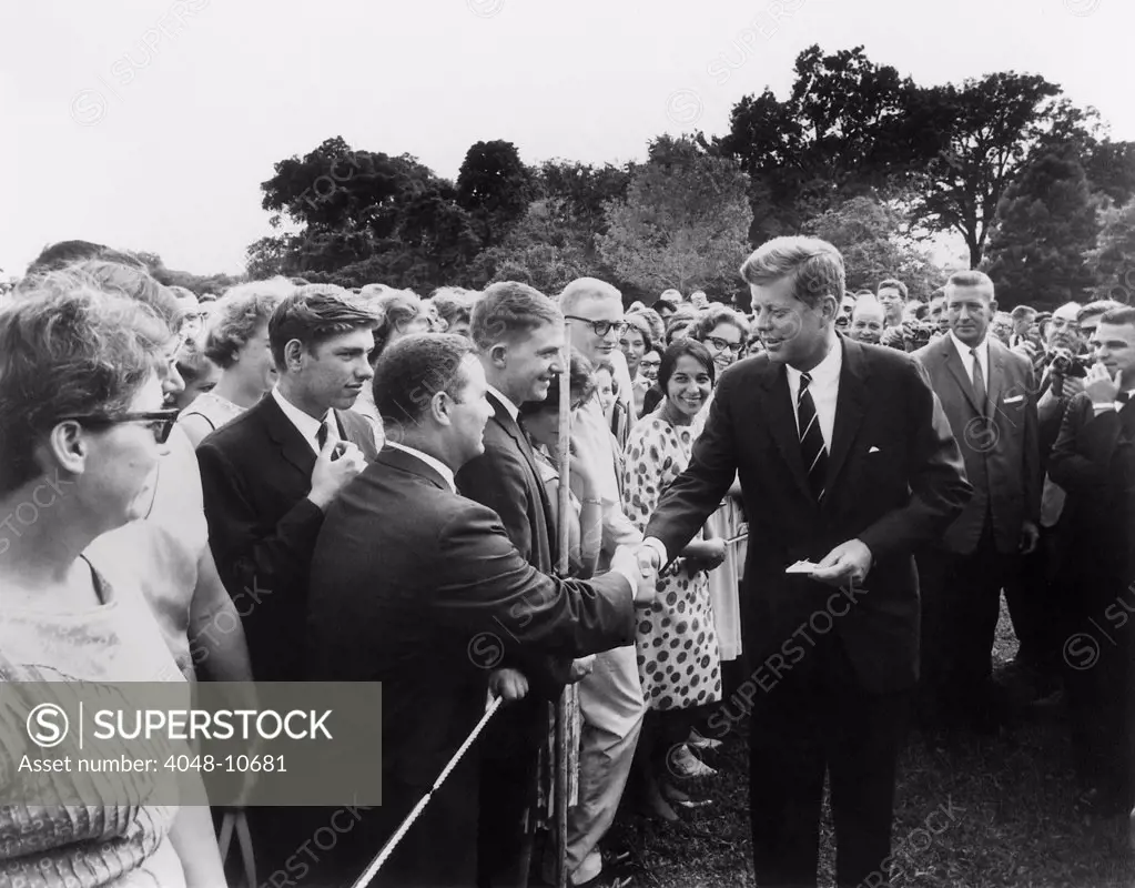 President John Kennedy meets with one of the first groups of Peace Corps volunteers. White House lawn, Aug. 11, 1961.