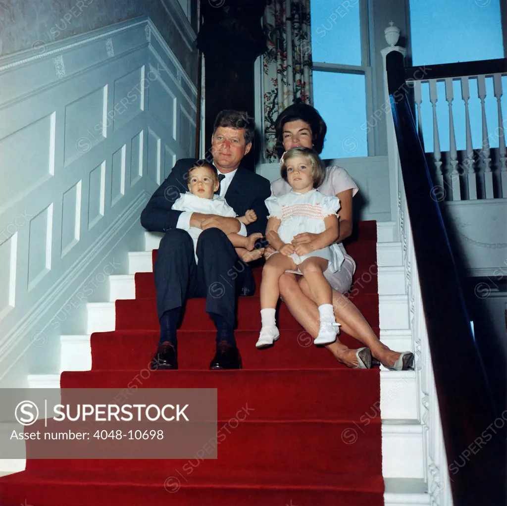 President John Kennedy and his family at Hammersmith Farm, Rhode Island. The President holds son, John Jr, and Jacqueline Kennedy holds Caroline. Sept 29, 1961.
