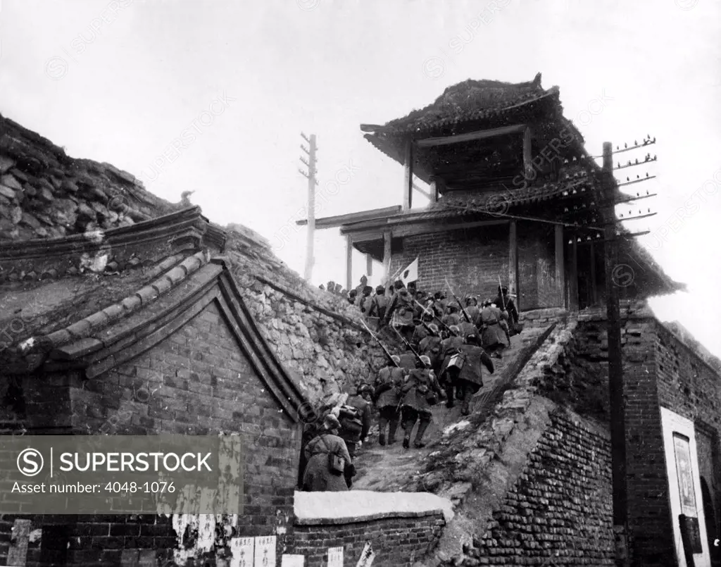 JAPANESE CLIMB CHINESE WALL  Photo, taken in Manchuria, shows Japanese infantry swarming up the steps of the main entrance to Chinchow, occupied by the Japanese. 1-19-32.
