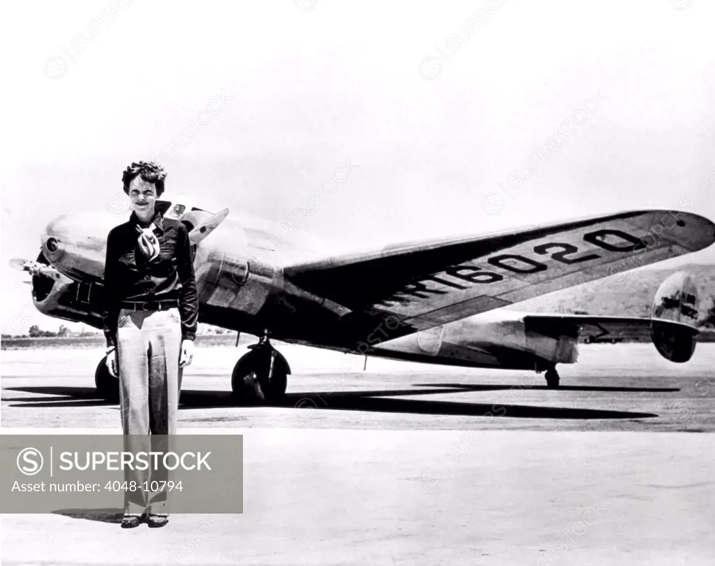 Amelia Earhart standing in front of the Lockheed Electra in which she disappeared in July 29, 1937.