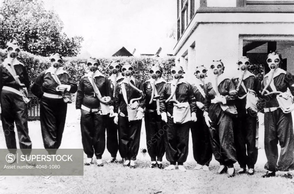 PREPAREDNESS IN SINGAPORE  Realizing that their homes are situated in a potential danger area, wives of admiralty officials at the Singapore Naval Base of Great Britain, are undergoing training in the use of respirators and anti-gas uniforms and masks.  8/21/36.