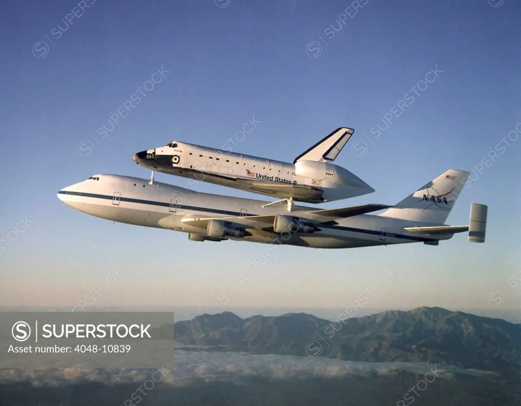 Space shuttle Atlantis atop the a customized 747 flies piggy back to the Kennedy Space Center after a ten month refurbishment. Sept. 1, 1998