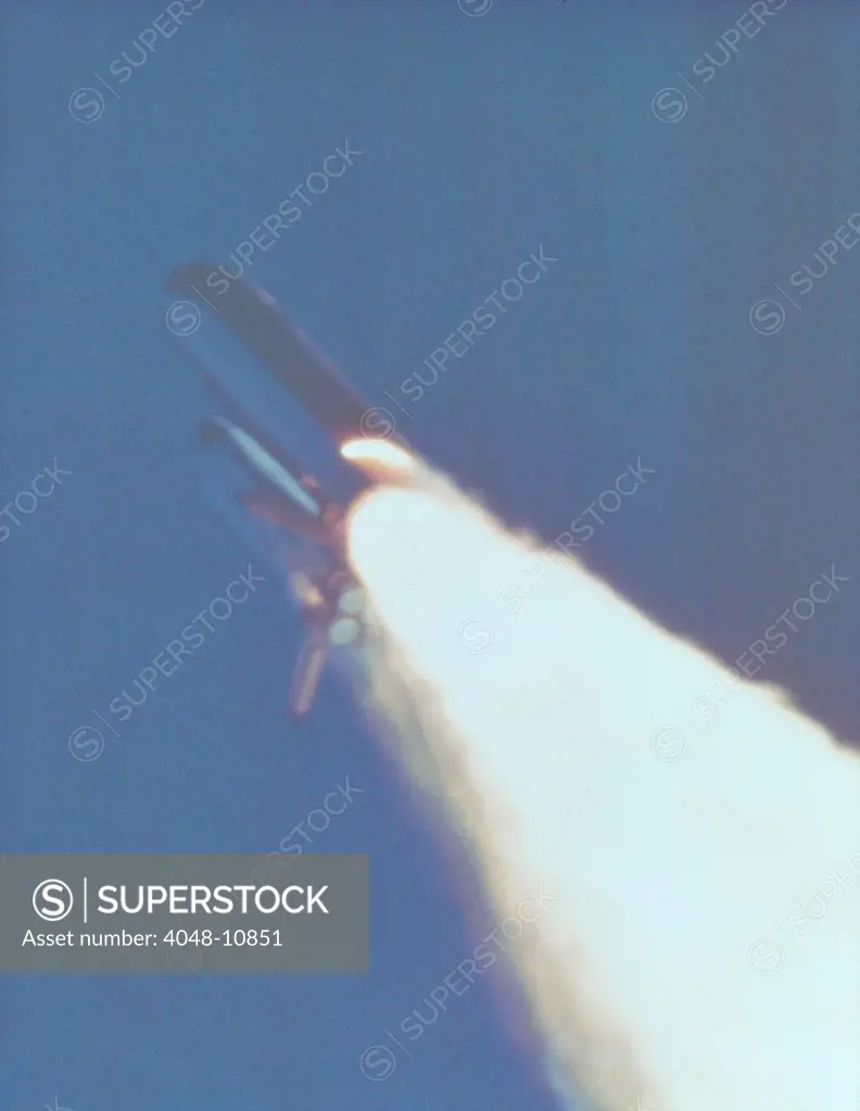 Space shuttle Challenger disaster. At 58.778 seconds into the flight, a large flame plume is visible on the booster rocket, indicating a breach in the motor casing. Jan. 28, 1986.