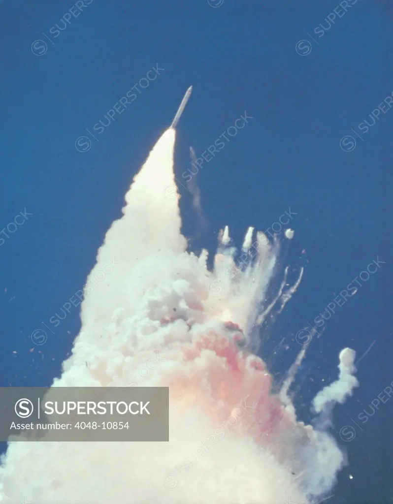 Space shuttle Challenger disaster. 76 seconds into flight, reddish-brown cloud envelops the disintegrating shuttle. Fragments of the shuttle can be seen tumbling against a background of fire. Jan. 28, 1986.