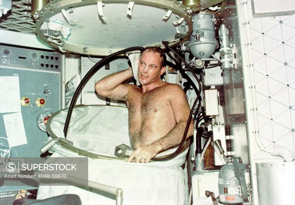 Astronaut Jack R. Lousma, taking a hot bath in the crew quarters aboard Skylab. The Skylab 3 crew conducted medical, scientific, and technological experiments during their 59 day mission from July 28 to Sept. 25, 1973.