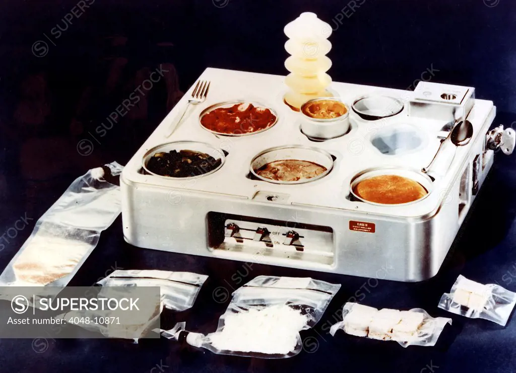 Skylab food heating and serving tray with food, drink, and utensils. The food on Skylab was a great improvement over liquefied food from plastic tubes of earlier spaceflights. 1970.