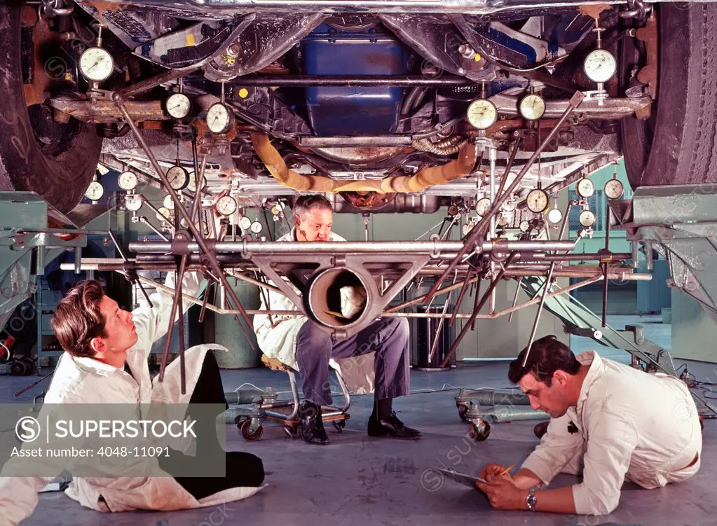 Ford test engineers take readings on a car chassis to detect signs of metal fatigue. Ford Motor Company, Dearborn Michigan, 1966. Photo: John G. Zimmerman Archive/Courtesy Everett Collection