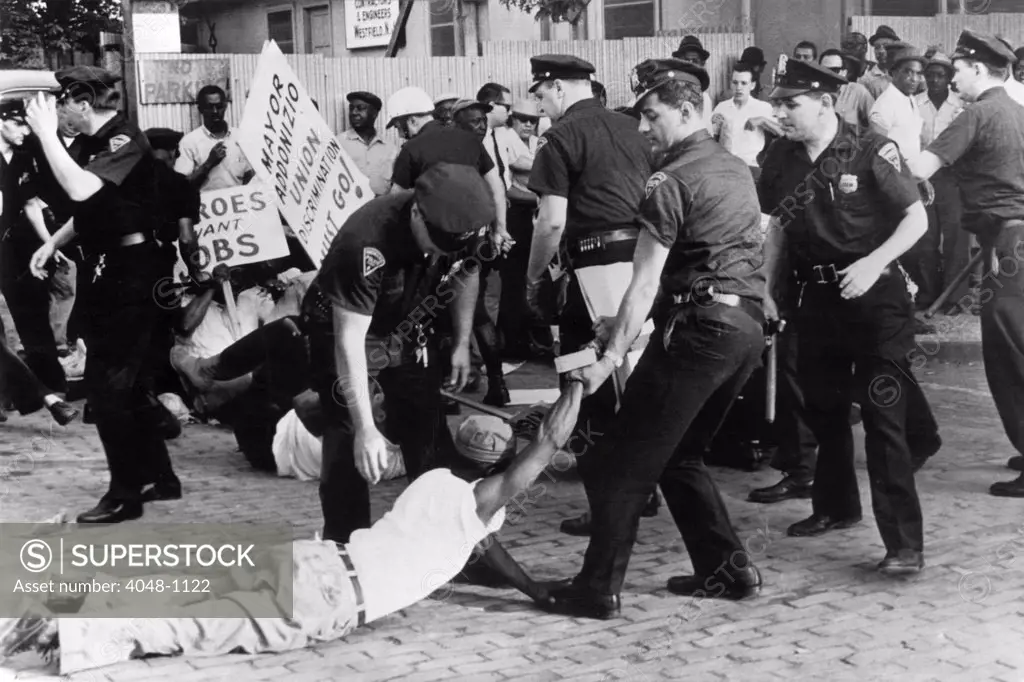 Police attempt to break up demonstration against racial discrimination in jobs at construction site of new Barrington High School, 7/3/63, Newark, NJ.