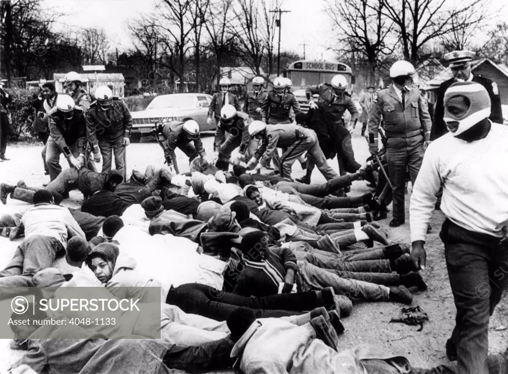 CIVIL RIGHTS, Social Circle, Georgia, State troopers arrest demonstrators blocking the path of a school bus protesting school conditions. February 15, 1968