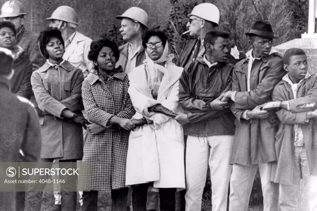 Demonstrators lock arms in front of the Dallas County courthouse in Selma, Alabama. Sheriff Jim Clark had them all arrested, 1965