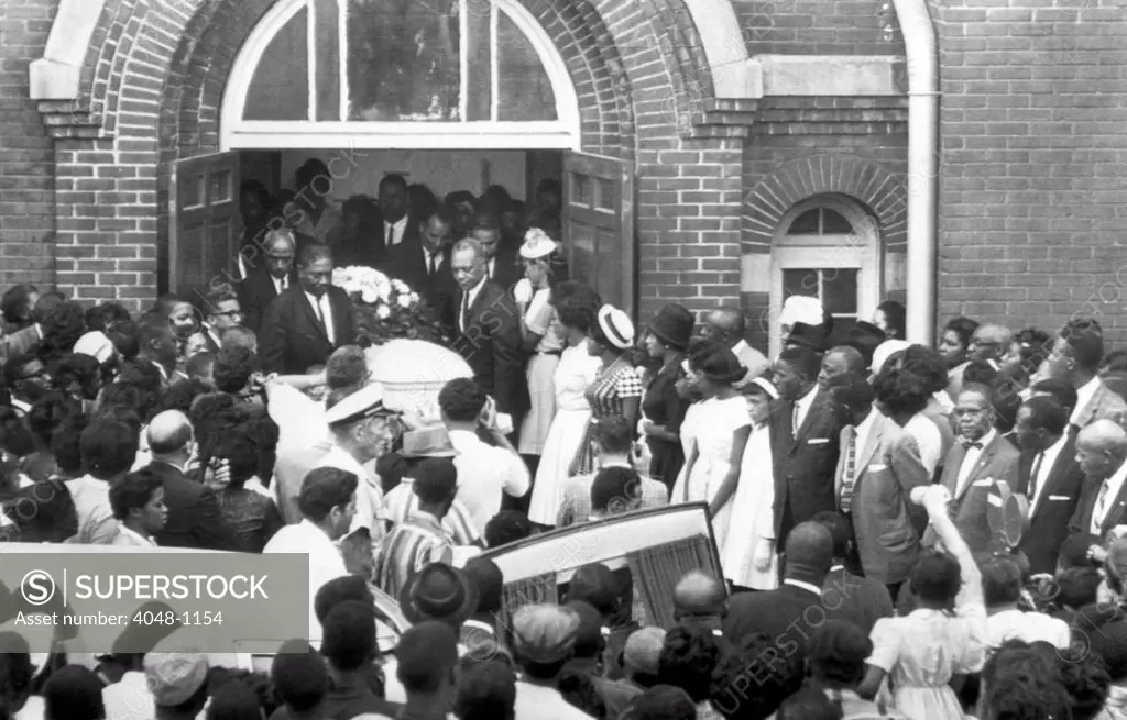 Hundreds of people attend the funeral of 14-year-old Carol Robertson in Birmingham, Alabama. She was killed in the bombing of 16th Street Baptist Church with three other girls, 1963