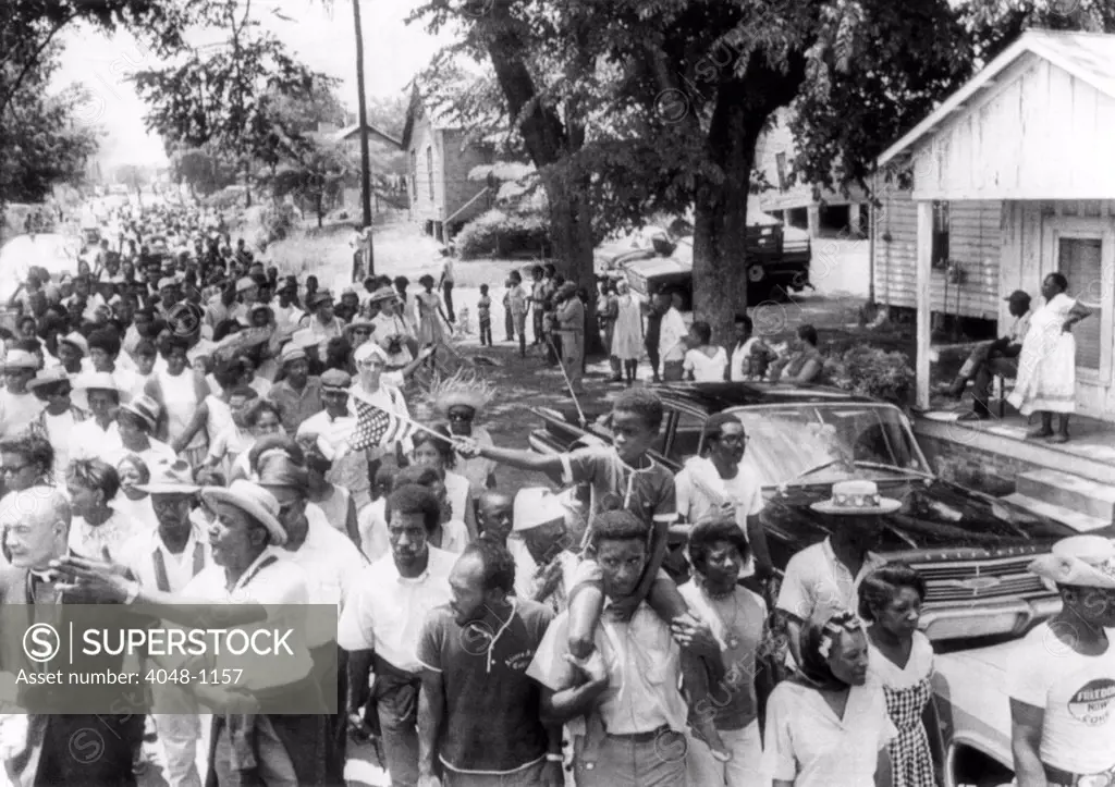 'Mississippi Freedom Marches' enter the small town of Granada, Mississippi. Floyd McKissick (front left with outstretched arm), CORE national chairman, calls for all to join the march, 1966