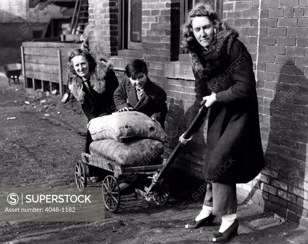 Mrs Margaret Simpler, Joseph McCuen and Mary Moka of Philadelphia deliver their own coal because of a shortage of delivery help, Philadelphia, PA, 12/31/43