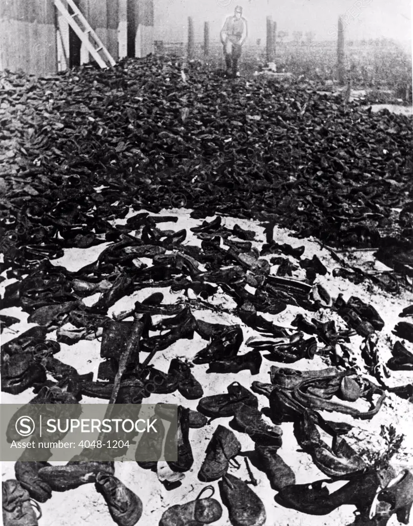 LUBLIN, POLAND--Shoes worn by the millions of men, women and children who marched through the gatess of the annihilation camp. Packed into a storehouse for sorting and salvage, the shoes spill out through the windows and doors of the hut. 9/13/44.