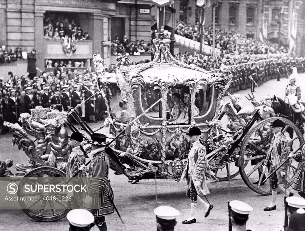 The magnificent state coach, King George VI and Queen Elizabeth I seated inside, passing through Trafalgar Square to Westminster Abbey, during the coronation procession. 5/18/37.