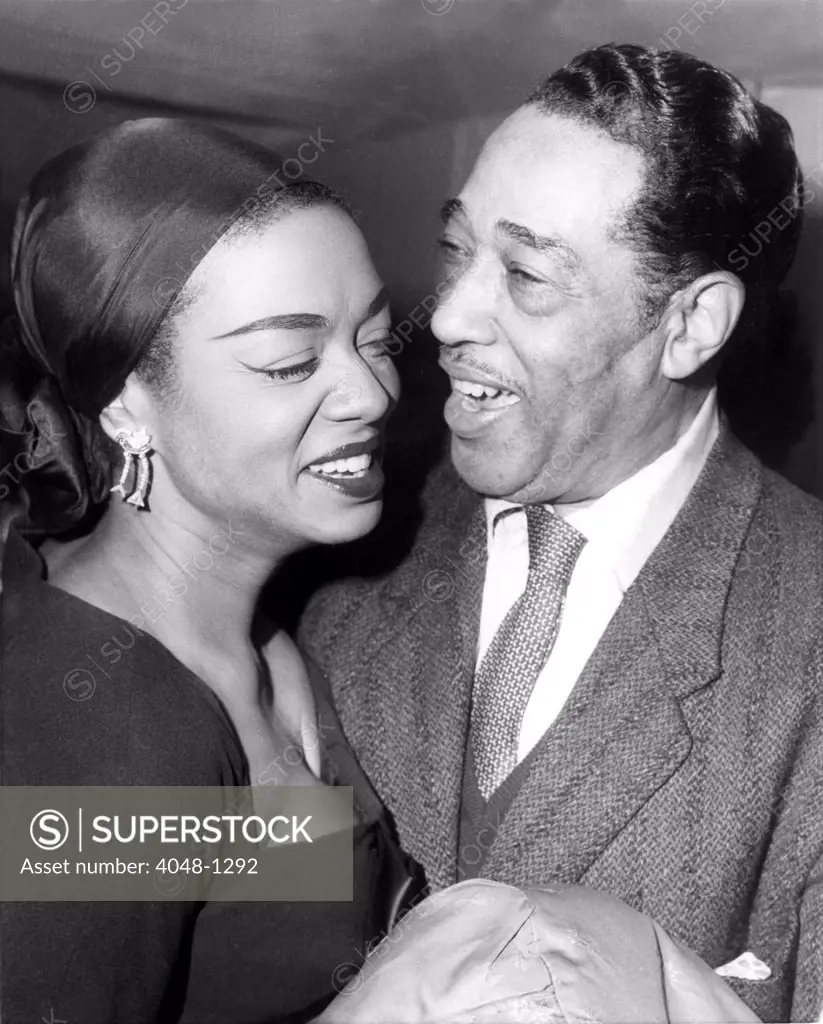 PARIS: American jazz band leader Duke Ellington chats with pianist-singer Hazel Scott at a reception given in his honor at the American Cultural Center in Paris. The Duke is currently giging a series of jazz concerts in Paris. 10/29/58