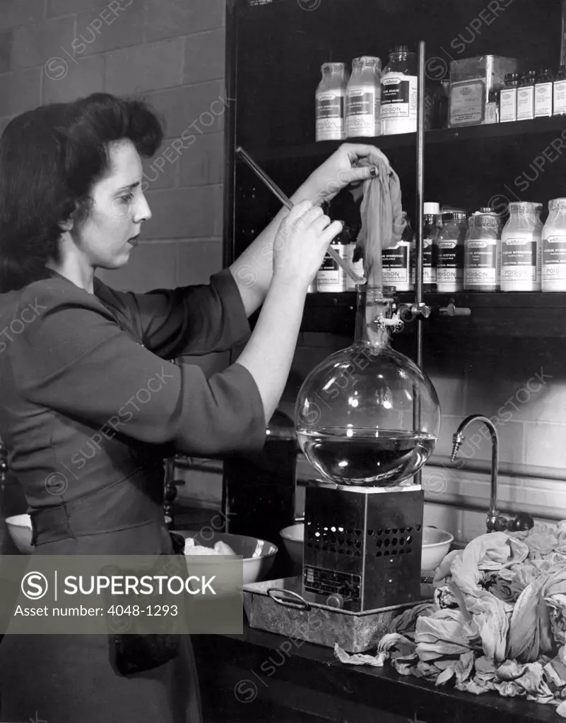 DuPONT COMPANY LABORATORY--Woman starting a pair of used nylons through a process developed at the laboratory which chemically unravels the stockings all the way back to their original complex components.(1940's)