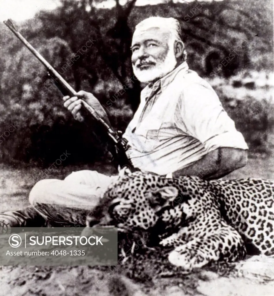 ERNEST HEMINGWAY with leopard he has killed in Uganda, 1/24/54.
