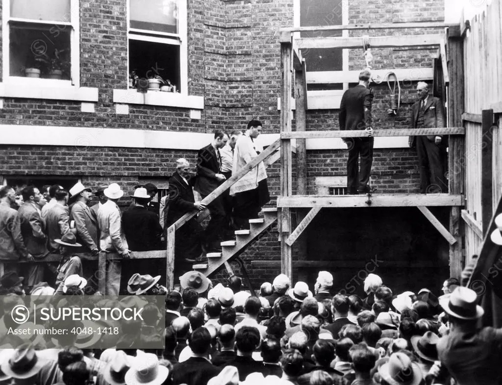 Roscoe 'Red' Jackson (behind priest) walks up the steps before he is hanged. He was convicted of killing a travelling salesman who gave him a ride. Galena, Missouri, 1937