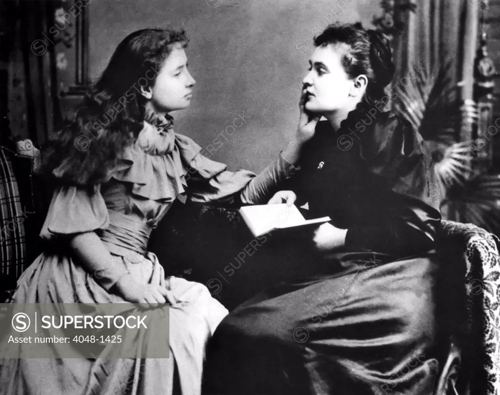 Photo illustrates how Helen Keller (left) 'hears' her instructor, Anne Sullivan by feeling the vibrations of her lips.