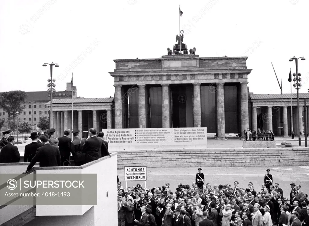 JOHN F. KENNEDY-Viewing the Berlin Wall from a platform at the Brandenburg Gate, Berlin. 6/27/63