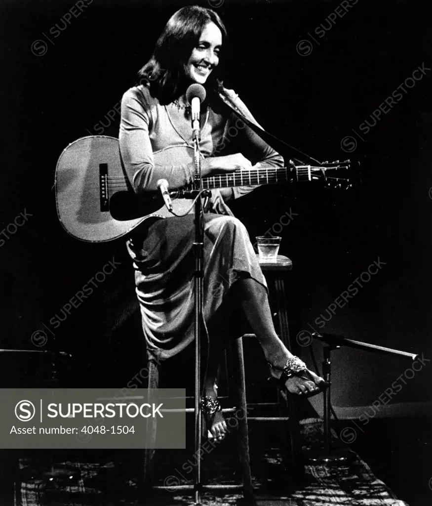 Joan Baez relaxes between songs during her special public television concert AN HOUR WITH JOAN BAEZ (TV, 1974)