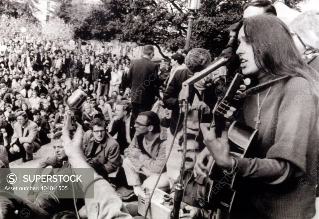 12-2-64 BERKELEY, CALIf.: Folk singer Joan Baez strums her guitar and sings freedom songs during a sit-in at the University of California at Berkeley.