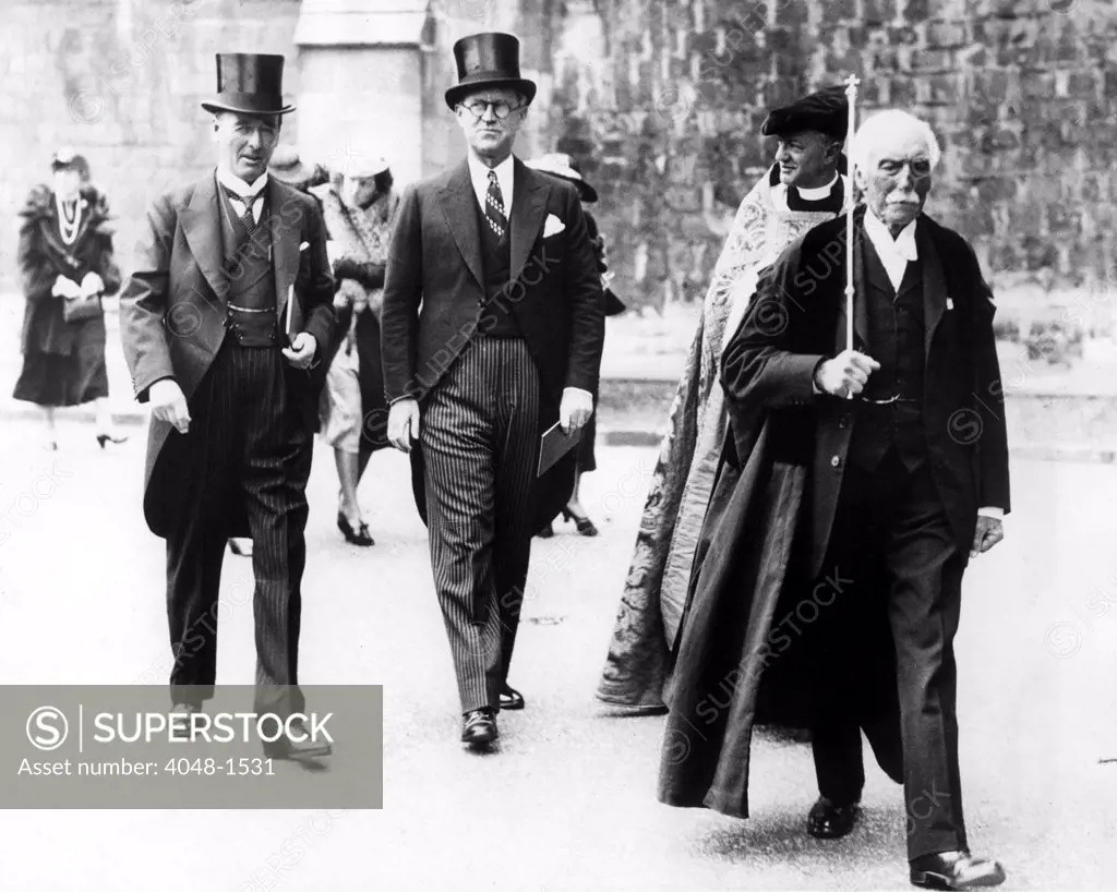 WINCHESTER, ENG: Joseph P. Kennedy (center), U.S. Ambassador to Britain, walking with Lord Mottistone (left), Lord Lieutenant of Hampshire, and the Very Rev. Dr. E.G. Selwyn (right, partly obscured) Dean of Winchester, 7/18/38.
