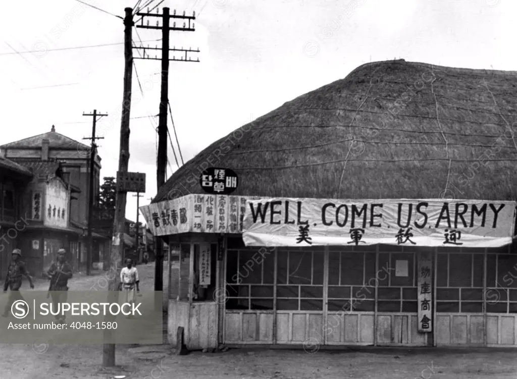7/8/50--SUWON, KOREA: A tea shop in Suwon put up a large sign to welcome US troops during the war.