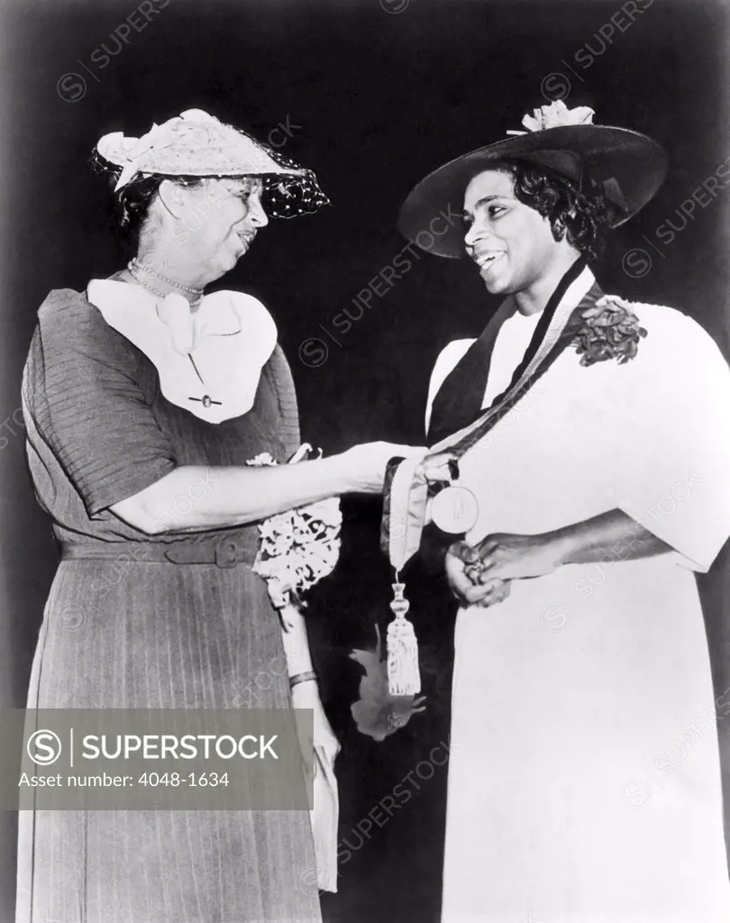 Eleanor Roosevelt gives singer Marian Anderson the Springarn Medal, an NAACP award for outstanding achievement by a black American, 1939