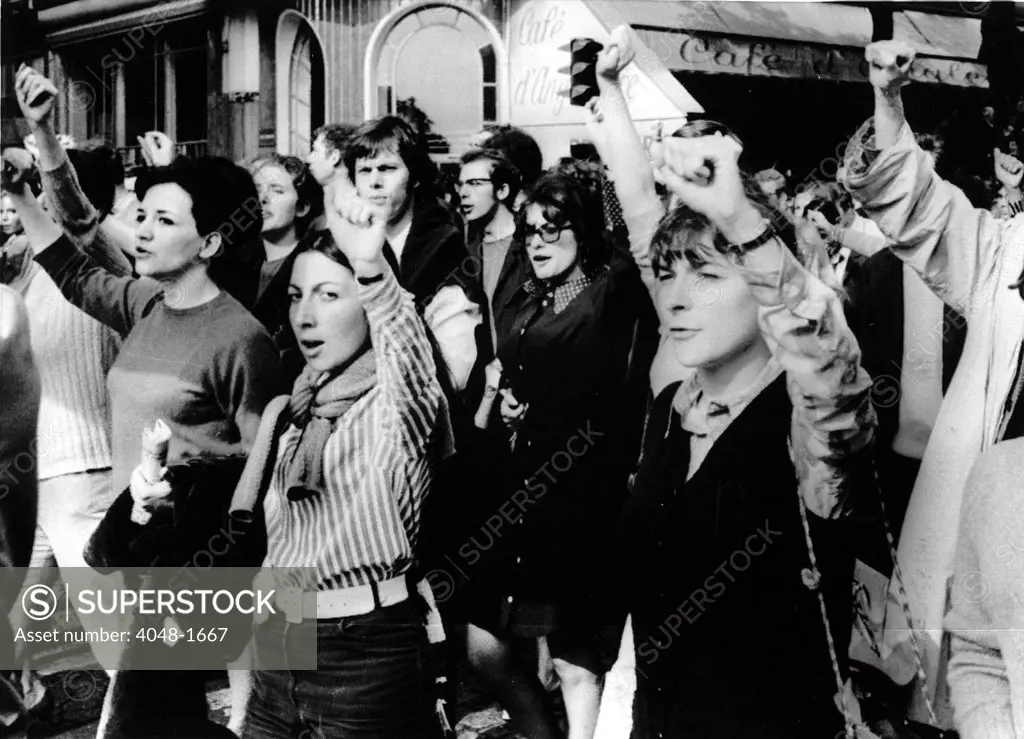 MARCHES-Men & women throw their arms in the air during a march through the streets of downtown Paris for popular government in France. 5/29/68