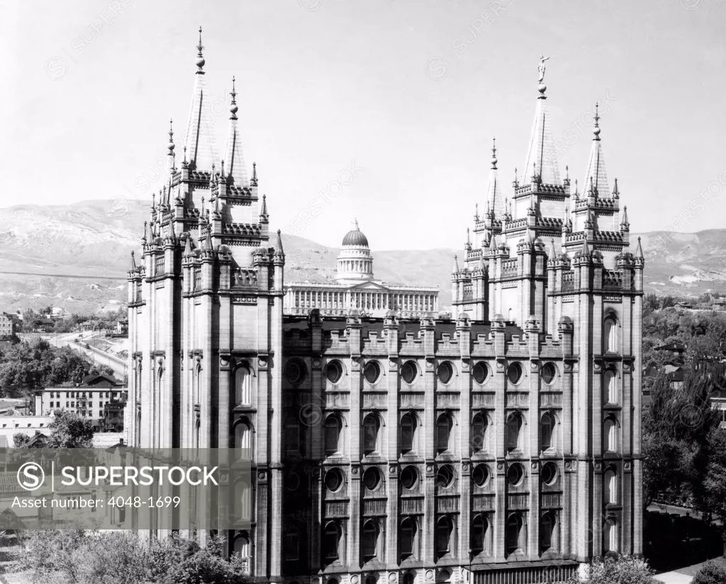 The Salt Lake City Mormon Temple with Utah's state Capitol Building in the background, 1930.