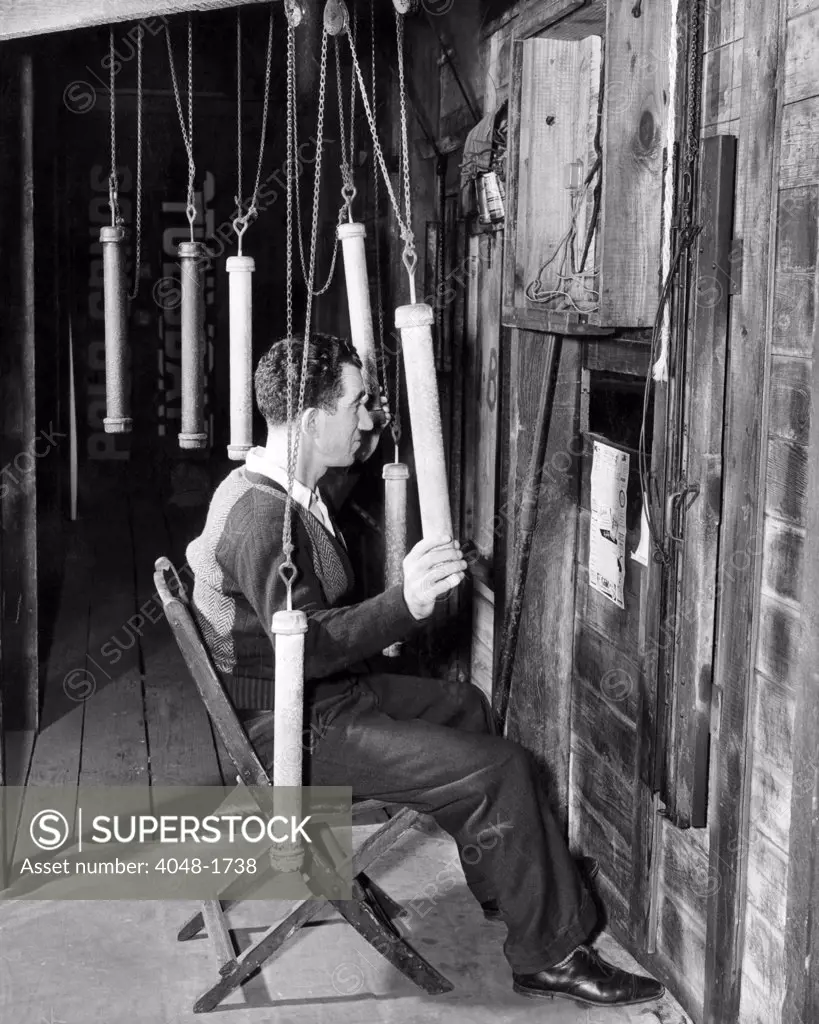 Man manipulating gadgets behind the scoreboard for the World Series, Yankee Stadium, New York City, October 4, 1939.