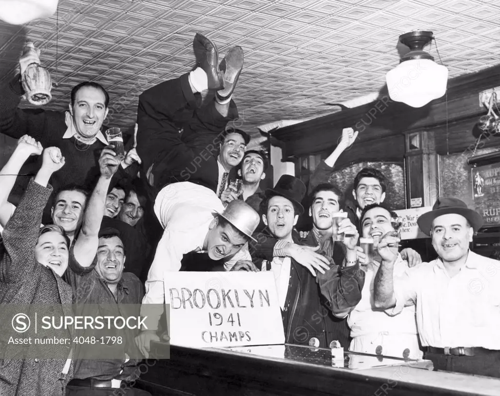Fans cheer a Brooklyn Dodgers Pennant Victory in a bar on Withers Street. New York City, September 25, 1941