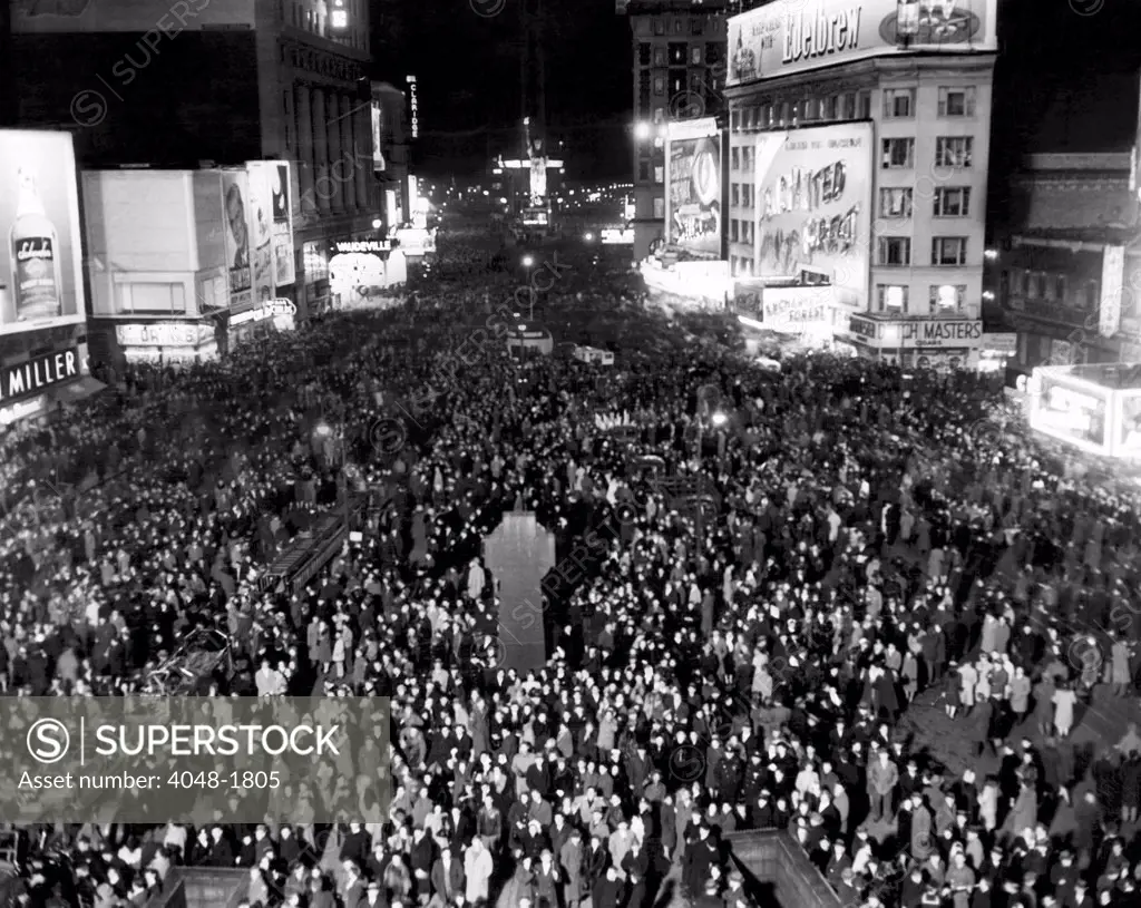 Thousands of people crowd Times Square awaiting the New Year, South from Duffy Square, New York City, December 31, 1945