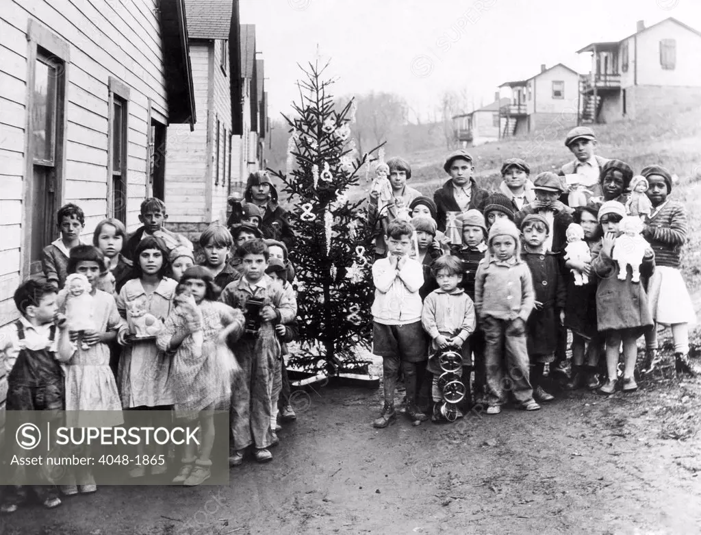 A group of poor miner's children in West Virginia hold the gifts they received from First Lady Lou Hoover, 1931