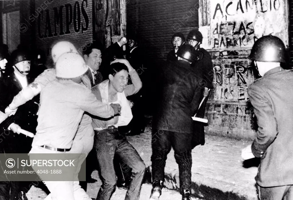 Mexico City:  Riot police battle a student demonstrator in a night of violence that ended with Mexican Army troops using bazookas and bayonets to break up anti-police demonstrators. August 30,1968.