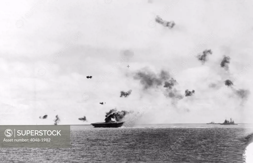 The aircraft carrier USS Yorktown being hit by dive bombers at the Battle of Midway, 1942