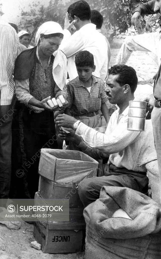 JERUSALEM: Soap is given to refugees at a distribution point set up for UNICEF supplies sent to relieve destitute families in Jordan, Syria and the United Arab Republic after the outbreak of hostilities between Israel and several Arab nations. 11/16/67.
