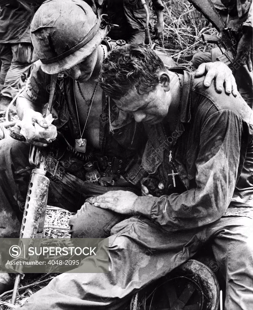Two soldiers comfort each other under the strain of combat in Pleiku, South Vietnam, 5/26/67.