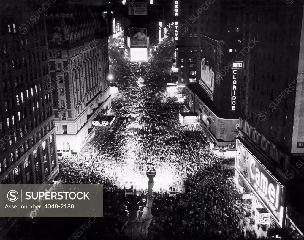 Thousands of people celebrating the end of a brownout in Times Square, New York, 1945.